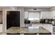 Updated kitchen features granite countertops, white cabinetry, and stainless steel appliances at 546 S Ellsworth Rd, Mesa, AZ 85208
