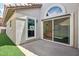 Charming back patio features sliding glass door, a half-moon window, and stucco wall at 7204 W Mcrae Way, Glendale, AZ 85308