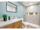 Modern bathroom featuring light-blue wall, granite countertops, and tiled shower at 7204 W Mcrae Way, Glendale, AZ 85308