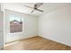 Empty bedroom with a ceiling fan, light-colored walls, and light-colored wood flooring at 7204 W Mcrae Way, Glendale, AZ 85308