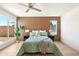 Cozy bedroom with wood-paneled accent wall, hardwood floors, and natural light at 7204 W Mcrae Way, Glendale, AZ 85308