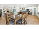 Bright, open-concept dining room featuring a wooden table and views into the living room and kitchen at 7204 W Mcrae Way, Glendale, AZ 85308