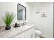 Stylish half bathroom with granite countertop, neutral paint, and contemporary accents at 7204 W Mcrae Way, Glendale, AZ 85308