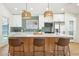 Spacious kitchen island with seating, perfect for gathering and entertaining guests at 7204 W Mcrae Way, Glendale, AZ 85308