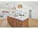 Spacious kitchen island with breakfast bar, marble countertop and decorative pendant lighting at 7204 W Mcrae Way, Glendale, AZ 85308
