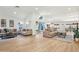 Bright and spacious living room with light hardwood floors, neutral tones, and modern furniture at 7204 W Mcrae Way, Glendale, AZ 85308