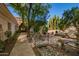 Beautiful backyard with a water feature, bridge, patio set, and desert landscaping at 7804 S 15Th Ave, Phoenix, AZ 85041