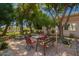 Backyard patio area with dining table, fountain, and lush landscaping creates a serene outdoor retreat at 7804 S 15Th Ave, Phoenix, AZ 85041
