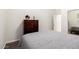 Bedroom featuring light grey quilt on bed and dark wood dresser at 7804 S 15Th Ave, Phoenix, AZ 85041