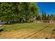 Expansive front yard with mature trees offering shade and privacy, plus a beautiful gate at 7804 S 15Th Ave, Phoenix, AZ 85041