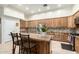 Well-equipped kitchen with stainless appliances, granite counters, and an island at 7804 S 15Th Ave, Phoenix, AZ 85041