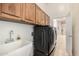 A practical laundry room with ample cabinet space and modern washer dryer unit at 7804 S 15Th Ave, Phoenix, AZ 85041
