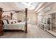 Spacious main bedroom with a four-poster bed and a private outdoor access at 7804 S 15Th Ave, Phoenix, AZ 85041