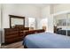 Bright primary bedroom featuring dark wood furniture, light walls and wood floors at 7804 S 15Th Ave, Phoenix, AZ 85041