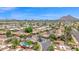 Community aerial view showcasing the neighborhood layout, landscaping, and nearby mountains at 7955 E Chaparral Rd # 73, Scottsdale, AZ 85250
