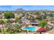 Community aerial view highlighting mature trees, a swimming pool, and surrounding mountain views at 7955 E Chaparral Rd # 73, Scottsdale, AZ 85250