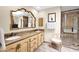 Bathroom featuring a double vanity with granite countertops and a glass-enclosed shower at 7955 E Chaparral Rd # 73, Scottsdale, AZ 85250