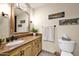 Cozy bathroom features a granite countertop, decorative mirror, and fish themed decor at 7955 E Chaparral Rd # 73, Scottsdale, AZ 85250