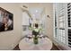 Bright breakfast nook with white shutters, seating for four and an opening to kitchen at 7955 E Chaparral Rd # 73, Scottsdale, AZ 85250