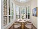 Cozy breakfast nook with bay window, shutters, and seating for four at 7955 E Chaparral Rd # 73, Scottsdale, AZ 85250
