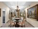 Elegant dining room with mirrored wall, chandelier, and seating for four at 7955 E Chaparral Rd # 73, Scottsdale, AZ 85250