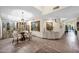 Open-concept dining area with a glass table, stylish chairs, and a decorative screen at 7955 E Chaparral Rd # 73, Scottsdale, AZ 85250