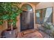 Inviting entryway features double doors, an arched window, and a charming courtyard view at 7955 E Chaparral Rd # 73, Scottsdale, AZ 85250