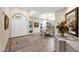 Bright foyer with a rug, white double doors, chandelier, and views to the dining area at 7955 E Chaparral Rd # 73, Scottsdale, AZ 85250