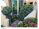 Inviting front entrance featuring a wrought iron gate, red brick walkway and mature landscaping at 7955 E Chaparral Rd # 73, Scottsdale, AZ 85250