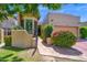Inviting walkway with a wrought iron gate, red brick pathway, and decorative landscaping at 7955 E Chaparral Rd # 73, Scottsdale, AZ 85250