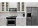Bright kitchen featuring stainless steel appliances, white cabinets, and solid surface countertops at 7955 E Chaparral Rd # 73, Scottsdale, AZ 85250