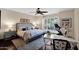 Well-lit main bedroom featuring a plush bed, a window seat, and a dedicated workout corner at 7955 E Chaparral Rd # 73, Scottsdale, AZ 85250