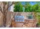 Built-in outdoor kitchen features a stone surround and stainless steel grill at 7955 E Chaparral Rd # 73, Scottsdale, AZ 85250