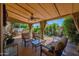 Relaxing covered patio with comfortable seating and a view of lush landscaping at 7955 E Chaparral Rd # 73, Scottsdale, AZ 85250