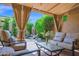 Cozy covered patio with comfortable seating, a water feature, and a lush garden view at 7955 E Chaparral Rd # 73, Scottsdale, AZ 85250