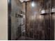 Modern shower with tile walls, glass doors, and convenient shelving for toiletries at 7955 E Chaparral Rd # 73, Scottsdale, AZ 85250
