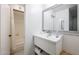 Bathroom featuring a modern vanity, framed mirror, and a glimpse into the shower area at 8055 E Thomas Rd # 104, Scottsdale, AZ 85251