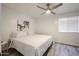 Cozy bedroom featuring a stylish ceiling fan, complemented by neutral decor and crisp white bedding at 8055 E Thomas Rd # 104, Scottsdale, AZ 85251
