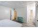 Well-lit bedroom showcasing gray floors, a decorative ceiling, and a view into an adjacent bathroom at 8055 E Thomas Rd # 104, Scottsdale, AZ 85251