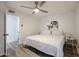 Bright bedroom features a stylish ceiling fan, complemented by neutral decor and light wood floors at 8055 E Thomas Rd # 104, Scottsdale, AZ 85251