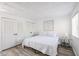 Bright bedroom featuring crisp white bedding, wood-look floors, complemented by stylish side tables at 8055 E Thomas Rd # 104, Scottsdale, AZ 85251