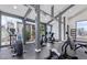 Bright community gym featuring workout equipment with floor to ceiling windows and modern interior design at 8055 E Thomas Rd # 104, Scottsdale, AZ 85251