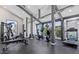 Community gym with exercise equipment, modern design and multiple large windows at 8055 E Thomas Rd # 104, Scottsdale, AZ 85251