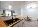 Modern kitchen sink and faucet with stylish hanging light fixture at 8055 E Thomas Rd # 104, Scottsdale, AZ 85251