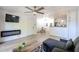 Open-concept living room with a fireplace and sleek, modern ceiling at 8055 E Thomas Rd # 104, Scottsdale, AZ 85251