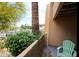 Relaxing outdoor patio area with lush greenery, desert landscaping, and a charming chair to enjoy the view at 8055 E Thomas Rd # 104, Scottsdale, AZ 85251