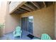 Private patio area with comfortable seating, sliding glass doors, and neutral tones for a cozy outdoor experience at 8055 E Thomas Rd # 104, Scottsdale, AZ 85251