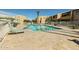 Well-maintained community pool area with lounge chairs, umbrellas, and beautiful landscaping for a relaxing experience at 8055 E Thomas Rd # 104, Scottsdale, AZ 85251