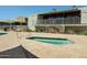 Relaxing community spa area next to the clubhouse with ample seating and well-manicured greenery at 8055 E Thomas Rd # 104, Scottsdale, AZ 85251