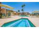 Resort-style pool and spa area featuring ample seating, palm trees, and beautifully maintained landscaping at 8055 E Thomas Rd # 104, Scottsdale, AZ 85251